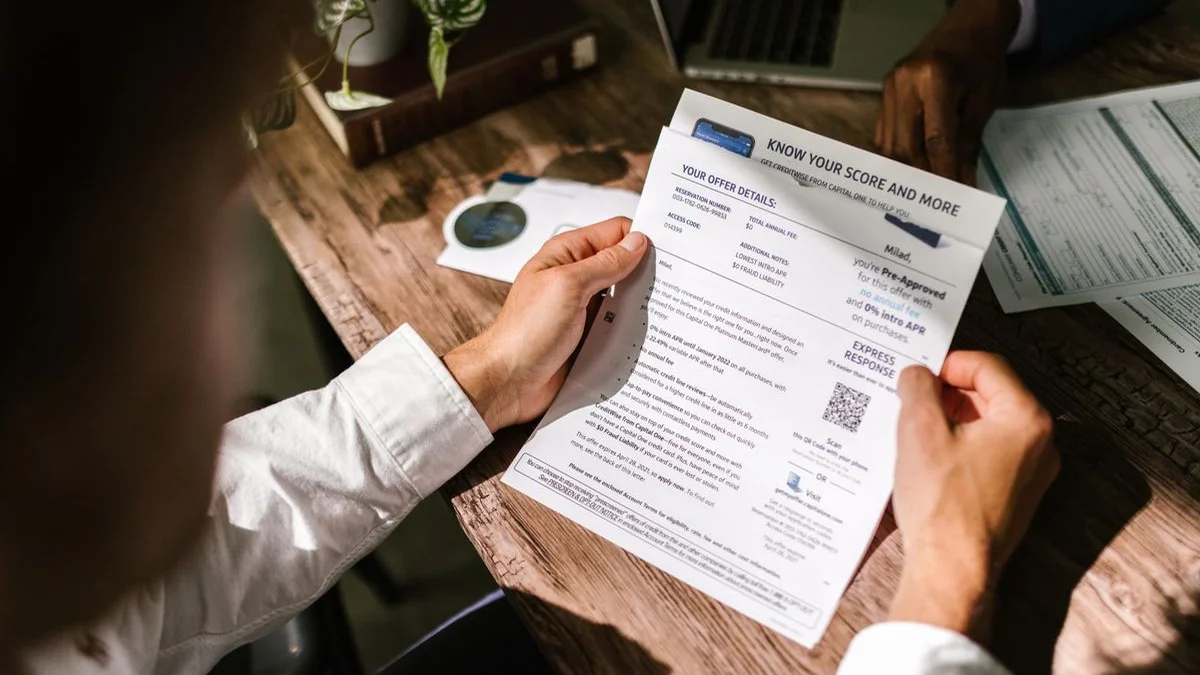 Person reviewing bank statement and discovering forgotten monthly software charges
